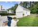 Large backyard featuring a detached garage, fire pit, and outdoor seating, perfect for entertaining and relaxing at 3203 Moonlight Dr, Charleston, SC 29414