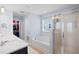 A bright bathroom featuring double sinks, a soaking tub, a large walk-in shower, and a walk-in closet at 3203 Moonlight Dr, Charleston, SC 29414