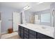Bright bathroom featuring a double vanity, quartz counters, framed mirror, soaking tub, and walk-in shower at 3203 Moonlight Dr, Charleston, SC 29414