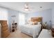 Cozy bedroom with a wooden headboard, ceiling fan, and light blue walls, creating a serene atmosphere at 3203 Moonlight Dr, Charleston, SC 29414