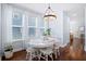 Cozy dining area with bright windows, hardwood floors, and an elegant light fixture at 3203 Moonlight Dr, Charleston, SC 29414