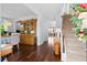 Warm entryway featuring hardwood floors, a staircase, and a view into the dining room and living spaces at 3203 Moonlight Dr, Charleston, SC 29414