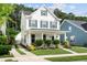 Charming two-story home featuring white siding, blue shutters, and a welcoming front porch at 3203 Moonlight Dr, Charleston, SC 29414