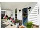 Charming front porch featuring rocking chairs, a swing, and a welcoming blue front door with a wreath at 3203 Moonlight Dr, Charleston, SC 29414