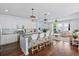 Open concept kitchen with island seating and views into the adjacent living room at 3203 Moonlight Dr, Charleston, SC 29414