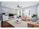 Stylish living room featuring a shiplap accent wall, comfortable seating, and abundant natural light at 3203 Moonlight Dr, Charleston, SC 29414