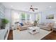 Bright living room featuring plush sofas, large windows, and stylish decor at 3203 Moonlight Dr, Charleston, SC 29414