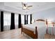 Serene main bedroom with hardwood floors, tray ceiling, and abundant natural light at 3203 Moonlight Dr, Charleston, SC 29414