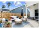 Inviting patio area with comfortable seating, stylish decor, a wood fence, and an umbrella for shade at 3203 Moonlight Dr, Charleston, SC 29414