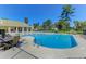 Relaxing community pool with lounge chairs and tables under a clear blue sky at 3203 Moonlight Dr, Charleston, SC 29414