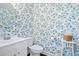 Charming powder room featuring vibrant floral wallpaper and elegant fixtures at 3203 Moonlight Dr, Charleston, SC 29414