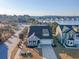 Charming aerial showcases a manicured neighborhood, lush trees, and scenic lake at 3278 Great Egret Dr, Johns Island, SC 29455