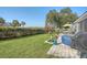 Landscaped backyard with fence, jacuzzi, patio, and lawn, with a water view in the distance at 3278 Great Egret Dr, Johns Island, SC 29455