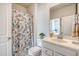 Bathroom features a vanity with sink, toilet, mirror, and decorative seashell patterned shower curtain at 3278 Great Egret Dr, Johns Island, SC 29455