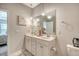 A bright bathroom features a double vanity with decorative lighting at 3278 Great Egret Dr, Johns Island, SC 29455