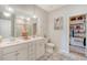 Bright bathroom features double vanity, decorative lighting, and walk-in closet at 3278 Great Egret Dr, Johns Island, SC 29455