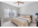 Bedroom with large windows, ceiling fan, and bed with decorative pillows, providing a relaxing atmosphere at 3278 Great Egret Dr, Johns Island, SC 29455