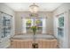 Sunlit dining area features a chandelier, wood table, and large windows with a view at 3278 Great Egret Dr, Johns Island, SC 29455
