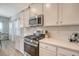 Well-lit kitchen featuring stainless steel appliances, white cabinets, and quartz countertops at 3278 Great Egret Dr, Johns Island, SC 29455