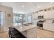Open kitchen boasts stainless appliances, white cabinets, and an island with bar stool seating at 3278 Great Egret Dr, Johns Island, SC 29455