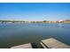 Picturesque lake view with a small dock and houses surrounding the shoreline on a clear day at 3278 Great Egret Dr, Johns Island, SC 29455