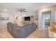 Inviting living room with gray sectional sofa, ceiling fan, and view into the hallway and bedroom at 3278 Great Egret Dr, Johns Island, SC 29455