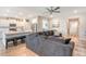 Open living room connects to kitchen, featuring a large gray sectional sofa and breakfast bar at 3278 Great Egret Dr, Johns Island, SC 29455