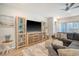Cozy living room features a large sectional sofa, entertainment center, and wood-look floors at 3278 Great Egret Dr, Johns Island, SC 29455