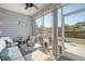 Screened patio with comfortable seating, fan, and outdoor views, perfect for relaxing at 3278 Great Egret Dr, Johns Island, SC 29455