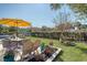A patio features a table and chairs set, an umbrella for shade, and well-kept landscaping at 3278 Great Egret Dr, Johns Island, SC 29455