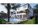 Beautiful backyard featuring a sparkling pool, lush landscaping, outdoor seating and patio, perfect for entertaining at 3307 Waterway Blvd, Isle of Palms, SC 29451