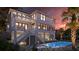 Gorgeous backyard with a sparkling pool, sun loungers, and a covered patio, perfect for outdoor living at 3307 Waterway Blvd, Isle of Palms, SC 29451