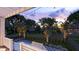 An outdoor view of the home's backyard with a luxurious pool, hot tub, and beautiful garden at 3307 Waterway Blvd, Isle of Palms, SC 29451