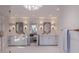 Dual vanities in this spacious bathroom are brightly lit and feature modern fixtures at 3307 Waterway Blvd, Isle of Palms, SC 29451