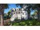 Well-appointed two-story home with meticulously landscaped grounds, a grand entrance, and a convenient golf cart at 3307 Waterway Blvd, Isle of Palms, SC 29451