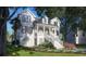 Stately two-story home with grand entrance, featuring elegant columns, manicured landscaping, and a welcoming front porch at 3307 Waterway Blvd, Isle of Palms, SC 29451