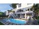 Expansive backyard with a pristine pool, spa, outdoor kitchen, and ample seating, ideal for outdoor living and entertainment at 3307 Waterway Blvd, Isle of Palms, SC 29451
