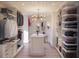 Brightly-lit custom walk-in closet featuring lots of shelves and storage at 3307 Waterway Blvd, Isle of Palms, SC 29451