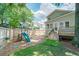 Large backyard with playset, deck with stairs, and mature trees at 332 Clayton Dr, Charleston, SC 29414