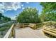 Beautiful wooded backyard with a deck and several benches overlooking a marsh at 332 Clayton Dr, Charleston, SC 29414