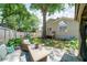 Landscaped backyard with patio seating area, playset, and lush greenery at 332 Clayton Dr, Charleston, SC 29414