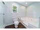 Bathroom featuring toilet, shower, and large soaking tub beneath a window bringing in natural light at 332 Clayton Dr, Charleston, SC 29414