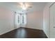 Bedroom with paneling, wood floors, ceiling fan, and windows with sheer curtains at 332 Clayton Dr, Charleston, SC 29414