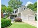Charming two-story home featuring a manicured lawn and a two-car garage at 332 Clayton Dr, Charleston, SC 29414