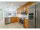 Well-lit kitchen with stainless steel appliances, wooden cabinets, and tile floors at 332 Clayton Dr, Charleston, SC 29414