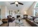 Open living room with vaulted ceilings, fireplace, dark floors, and comfortable seating at 332 Clayton Dr, Charleston, SC 29414