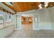 Sunroom with wood-paneled ceiling connecting to the kitchen through french doors at 332 Clayton Dr, Charleston, SC 29414