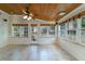 Sunroom with tile floors, multiple windows, and white wainscoting at 332 Clayton Dr, Charleston, SC 29414