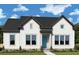 Charming, new construction home with a light blue front door, light-colored siding, and attractive landscaping at 340 Trailmore Ln, Summerville, SC 29486