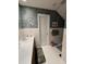 Bright bathroom with a single sink vanity, white tile, and green rug accents at 351 Duncan Chapel Rd, Harleyville, SC 29448